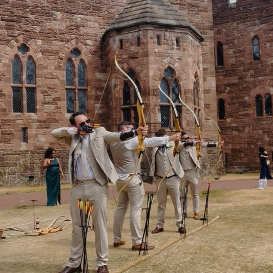 Groomsmen doing wedding archery